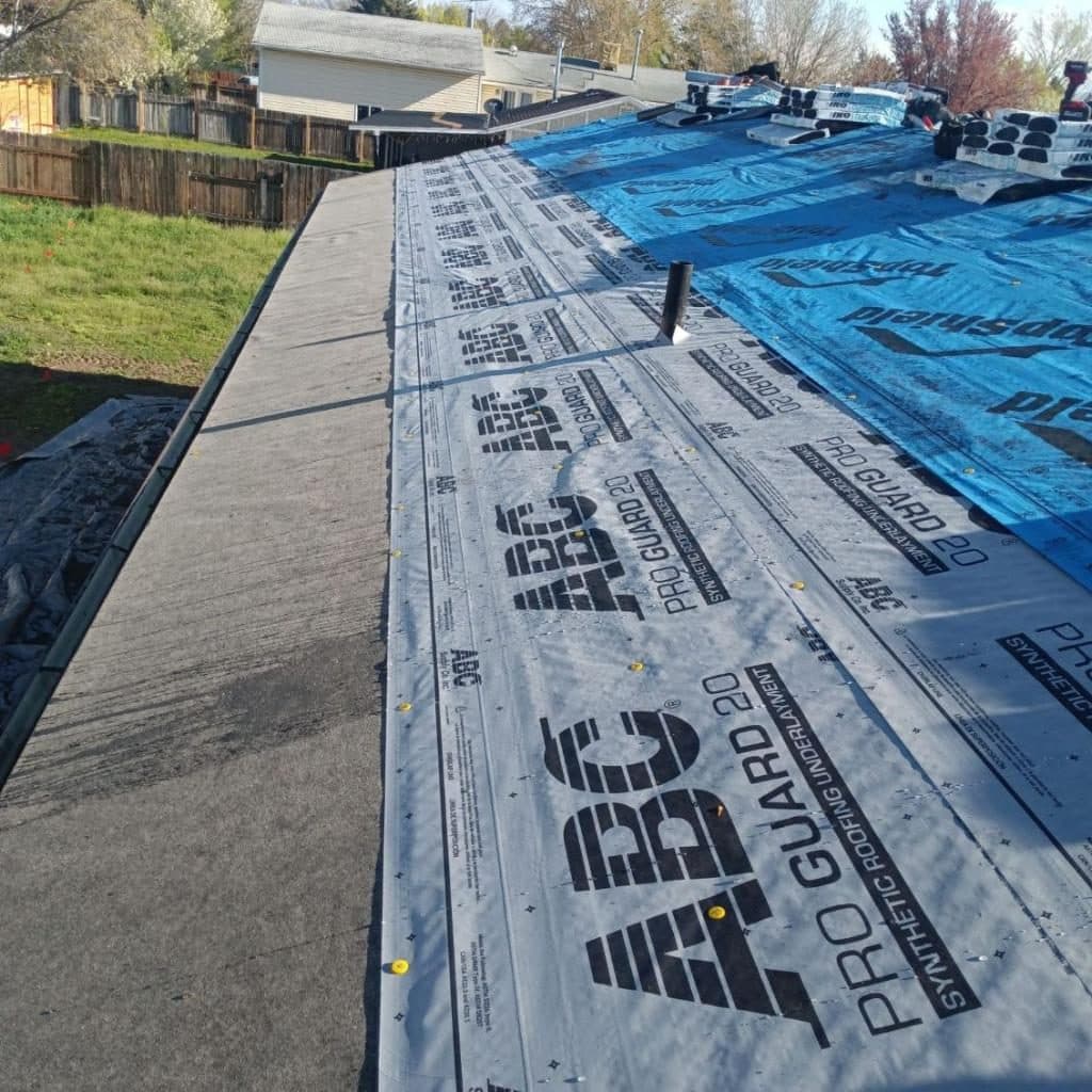 Ice-and-water shield along the eave, with synthetic underlayment covering the field above it.