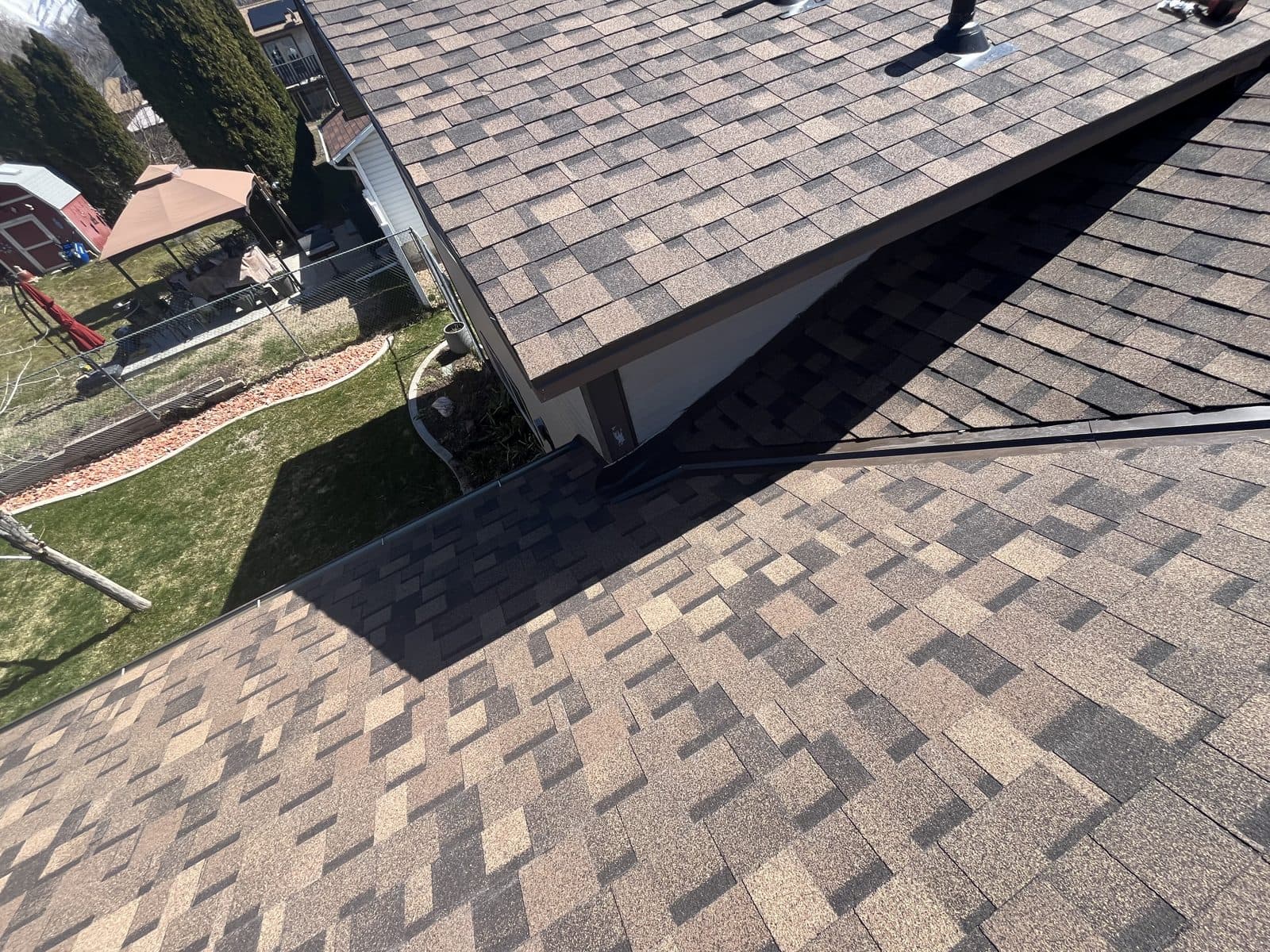 Close-up of a metal valley in a finished architectural shingle roof.